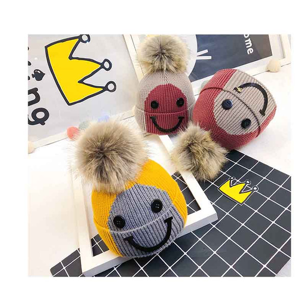 2019 New Color matching children's hat winter new Korean version of the button smiley wool hat baby warm hooded knit hat hair ball