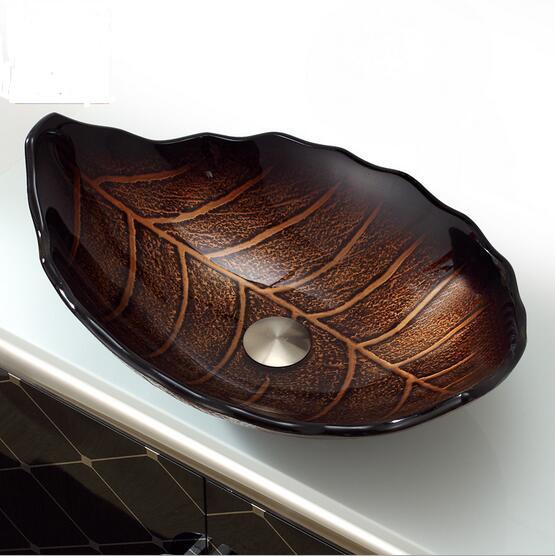 Leaf shape of the tempered glass basin with brown oval bathroom and toilet sink on the counter to install