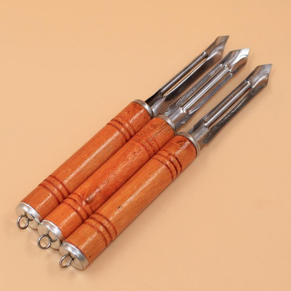 He pointed to a long wooden handle paring knife peeler fruits planer frying versatile kitchen tool knife