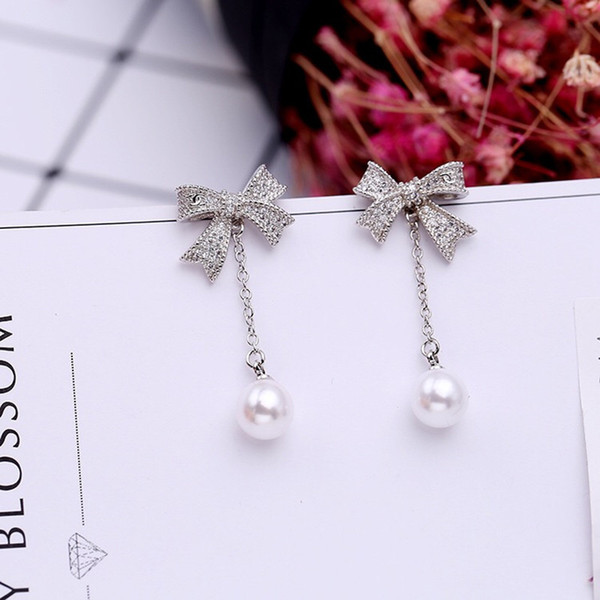 New European and American version of the long pearl earrings female 925 silver needle earrings simple tassel bow allergy