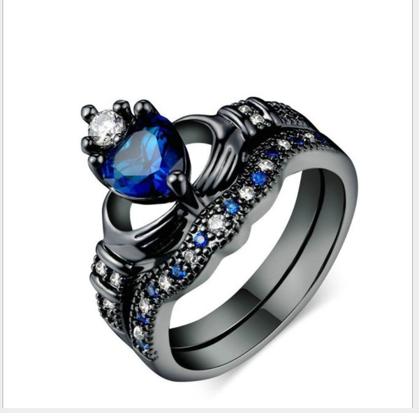 Double ring rings, women holding Sapphire Heart Shaped rings.