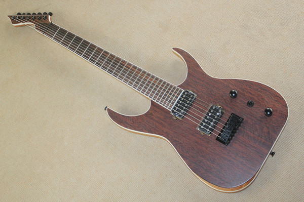 The seven-stringed electric guitar has a brown patterned face with elm body