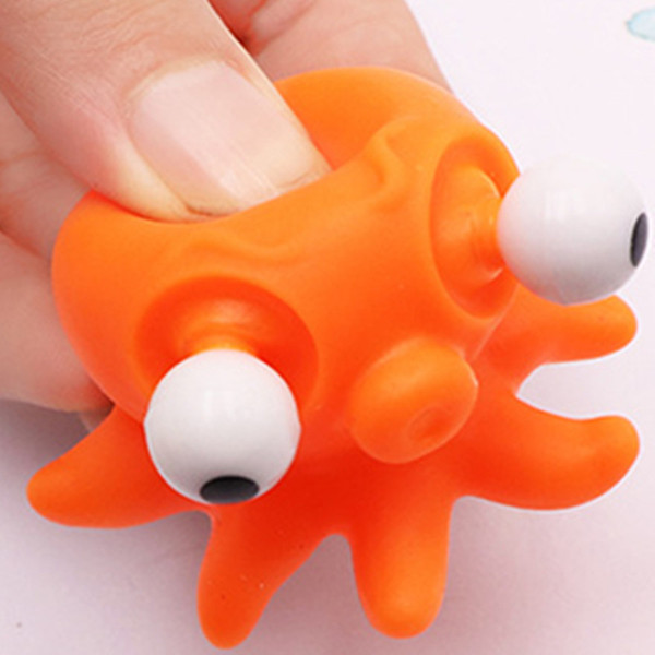 Release the pressure relief toy to squeeze a small toy doll with the eye flashing key chain.