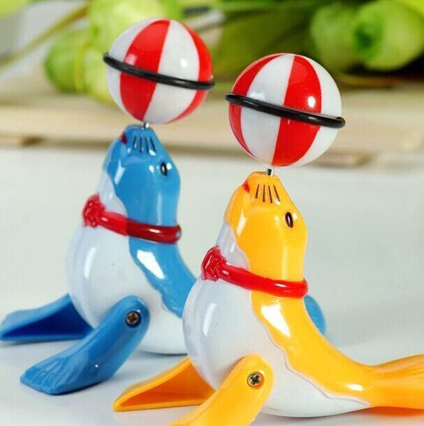 Rotating plastic toys Cross-border foreign trade creative children's puzzle Clockwork cartoon dolphins on the street stall wholesale to