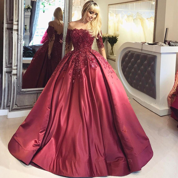 2017 Burgundy Bateau Ball Gown Prom Dresses Nude Shoulder Illusion Long Sleeves Backless Major Beaded Floor Length Sweep Train Evening Gowns