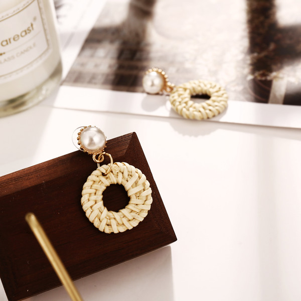 woven beige round wooden earrings with pearl pendants