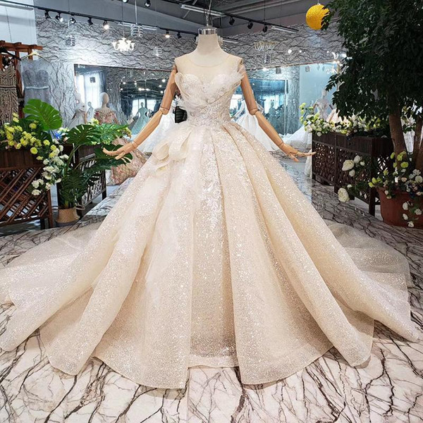 2019 Luxury PuffyBall Gown Wedding Dresses Sleeveless Open Keyhole Back Illusion Neckline Bow Applique Pattern Sequins Beach Bridal Gown