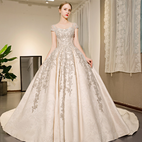 2018 Genuine OUYAFENGQING Princess Ball Gowns Boat Neck Cap Sleeves Appliques With Beads Wedding Dresses With Long Train In Satin