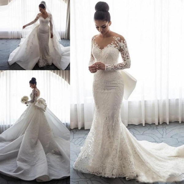 Designer Long Sleeves Mermaid Wedding Dresses Sheer Neck Illusion Lace Applique Bow Overskirts Button Back Chapel Train Bridal Gowns